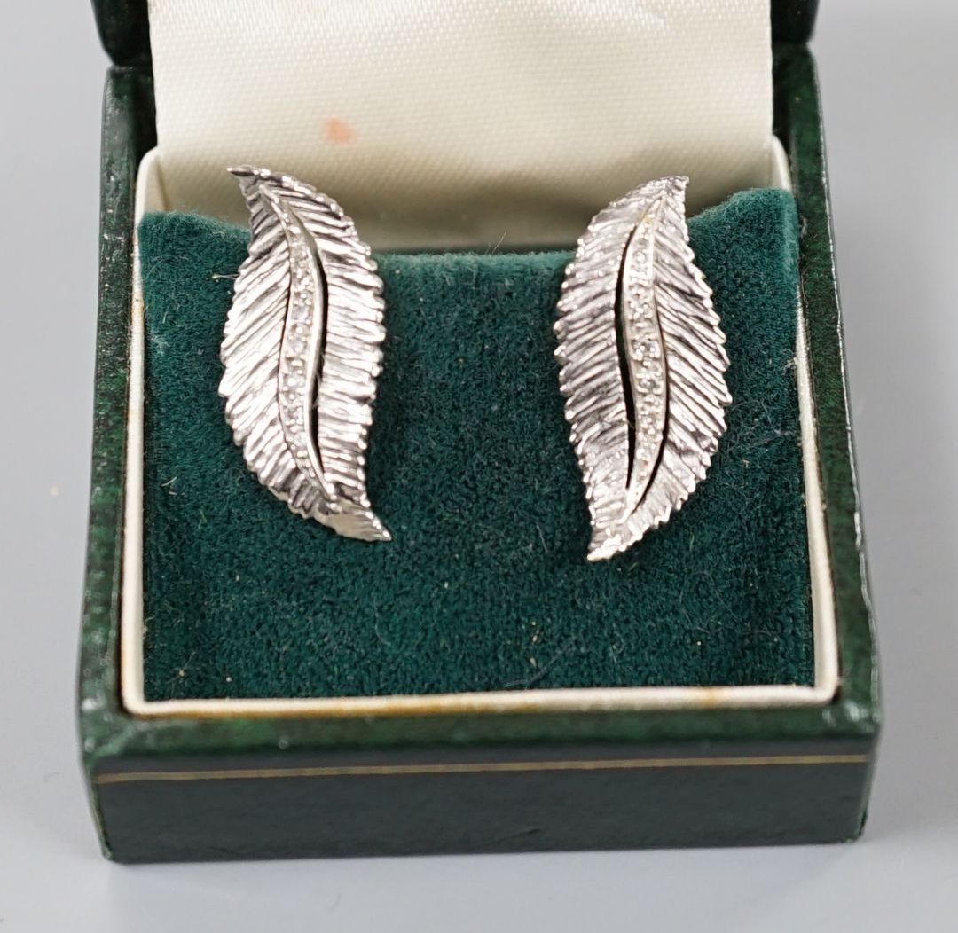 A pair of 9ct white gold and diamond chip set leaf earring, 22mm, gross weight 4.7 grams.